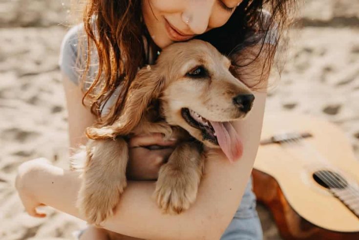 Woman Hugs A Dog — Veterinary Hospital In Lake Macquarie